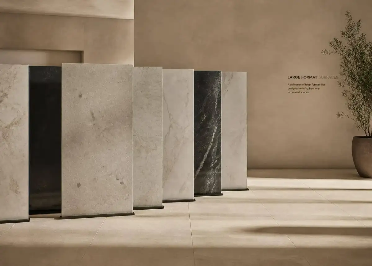 Large-format porcelain tile slabs standing in a warm-toned showroom